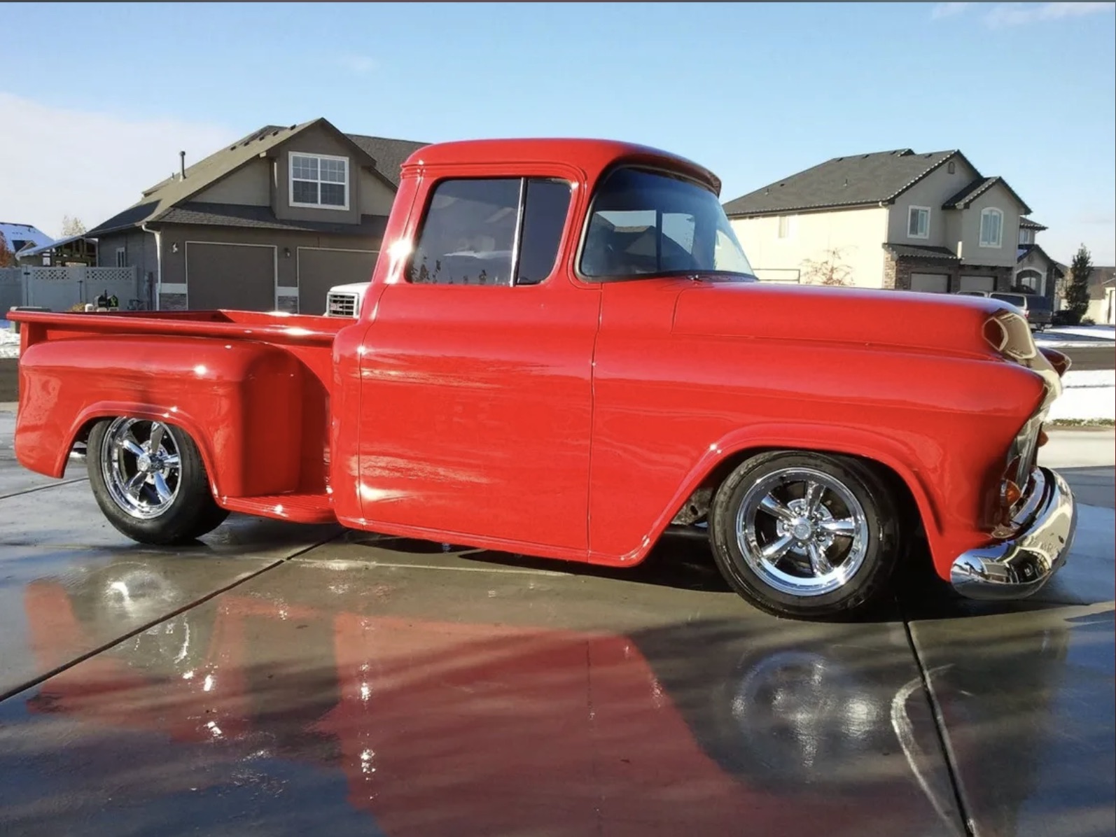 Custom red 1957 Chevy stepside pickup truck with chrome wheels in Boise, Idaho
